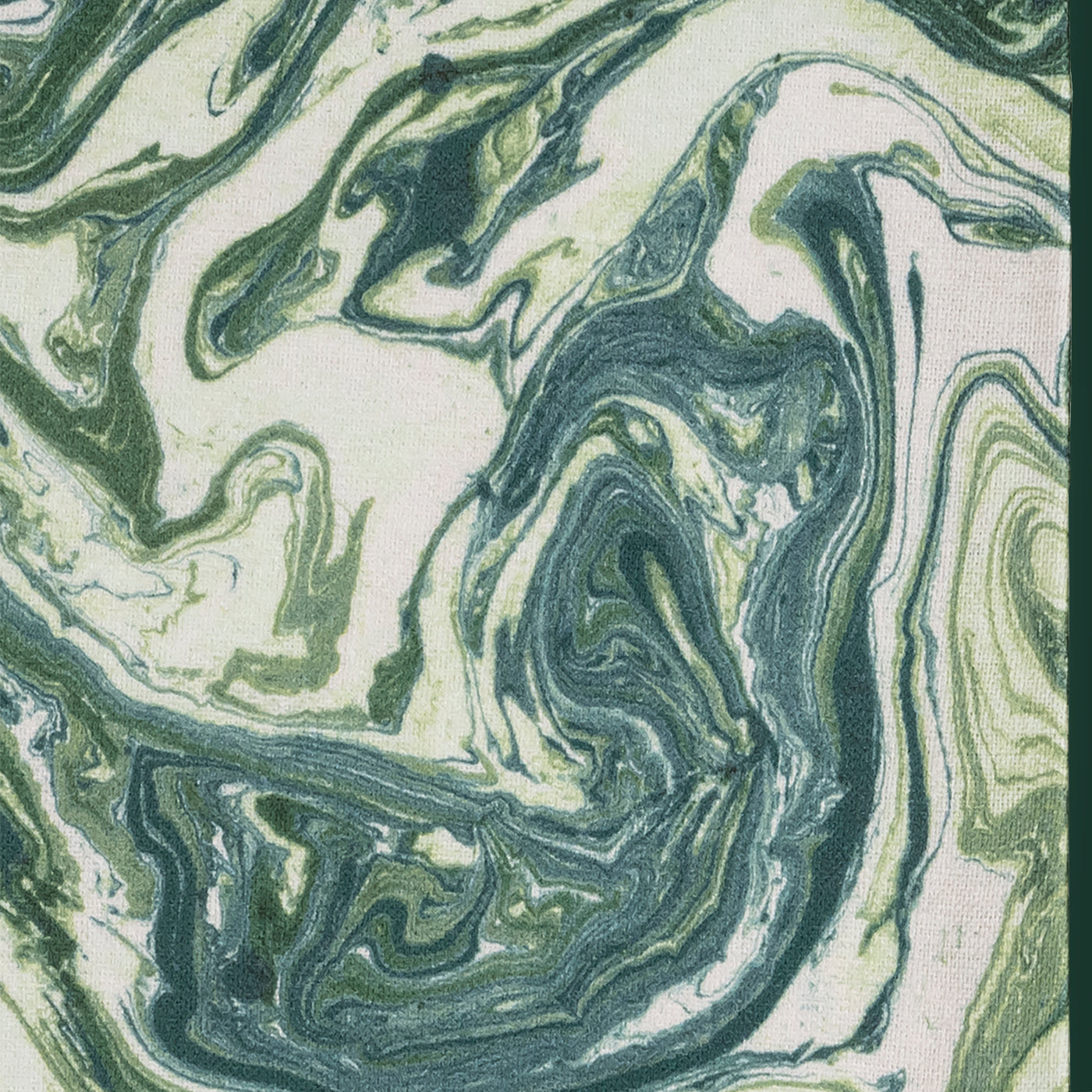 Close-up of swirling forest and sage green marble print on ivory linen fabric.
