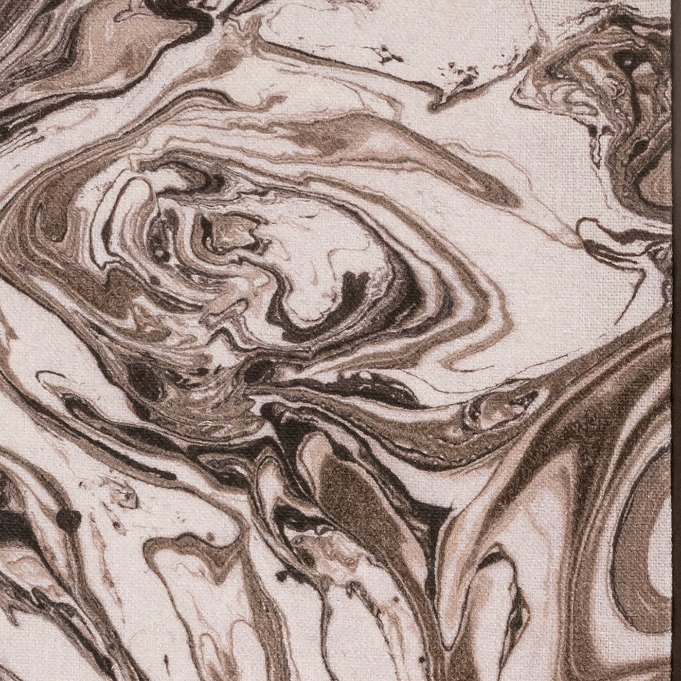 Close-up of mocha and ivory marbled print on linen sleep mask fabric.
