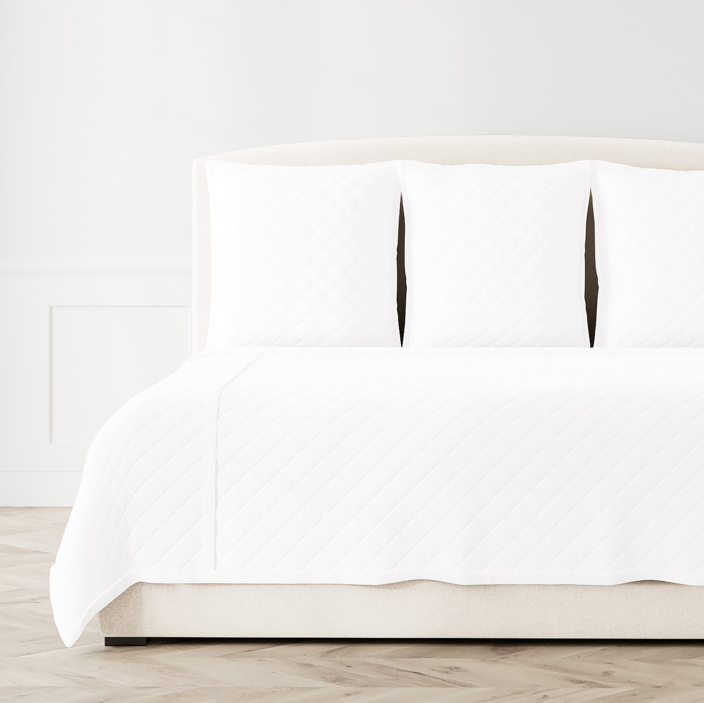 White Ann Gish Velvet coverlet set on bed, diamond quilted texture, styled with matching shams.