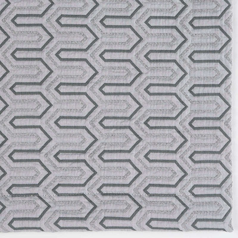Close-up of Celso de Lemos Vendome pillow cover in silver with raised geometric lattice weave.