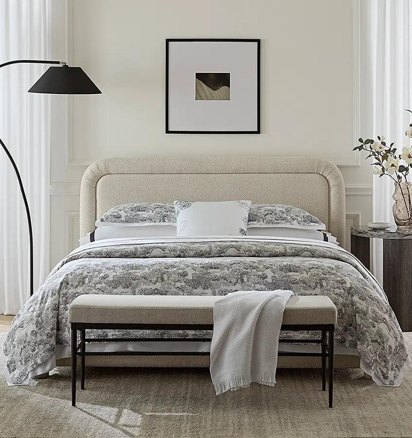 Sferra Viaterra duvet cover styled on bed with bench, floor lamp, and framed art.
