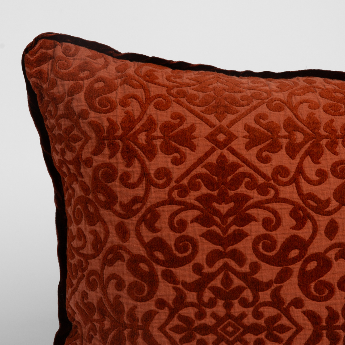 Close-up of Bella Notte Vienna sham in Autumn, showing damask velvet pattern with dark piped edge.