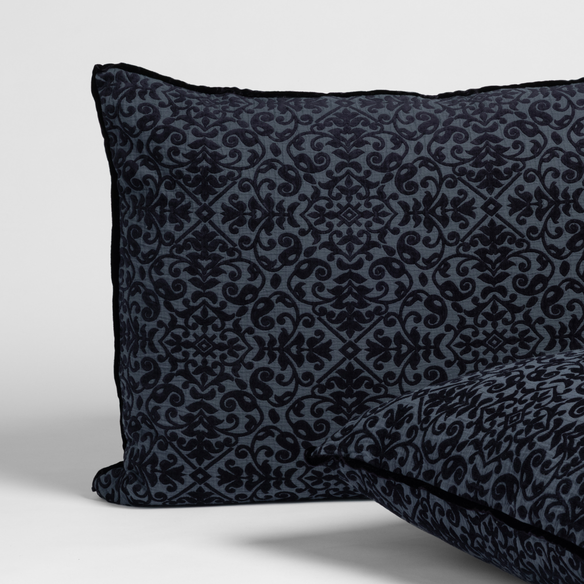 Slate Vienna sham close-up showing intricate dark damask pattern with contrast piped edge.