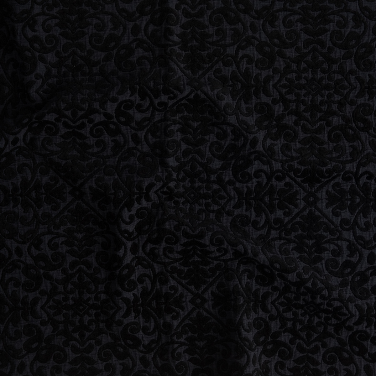 Close-up of Bella Notte Vienna coverlet in Corvino, showing damask jacquard weave detail.