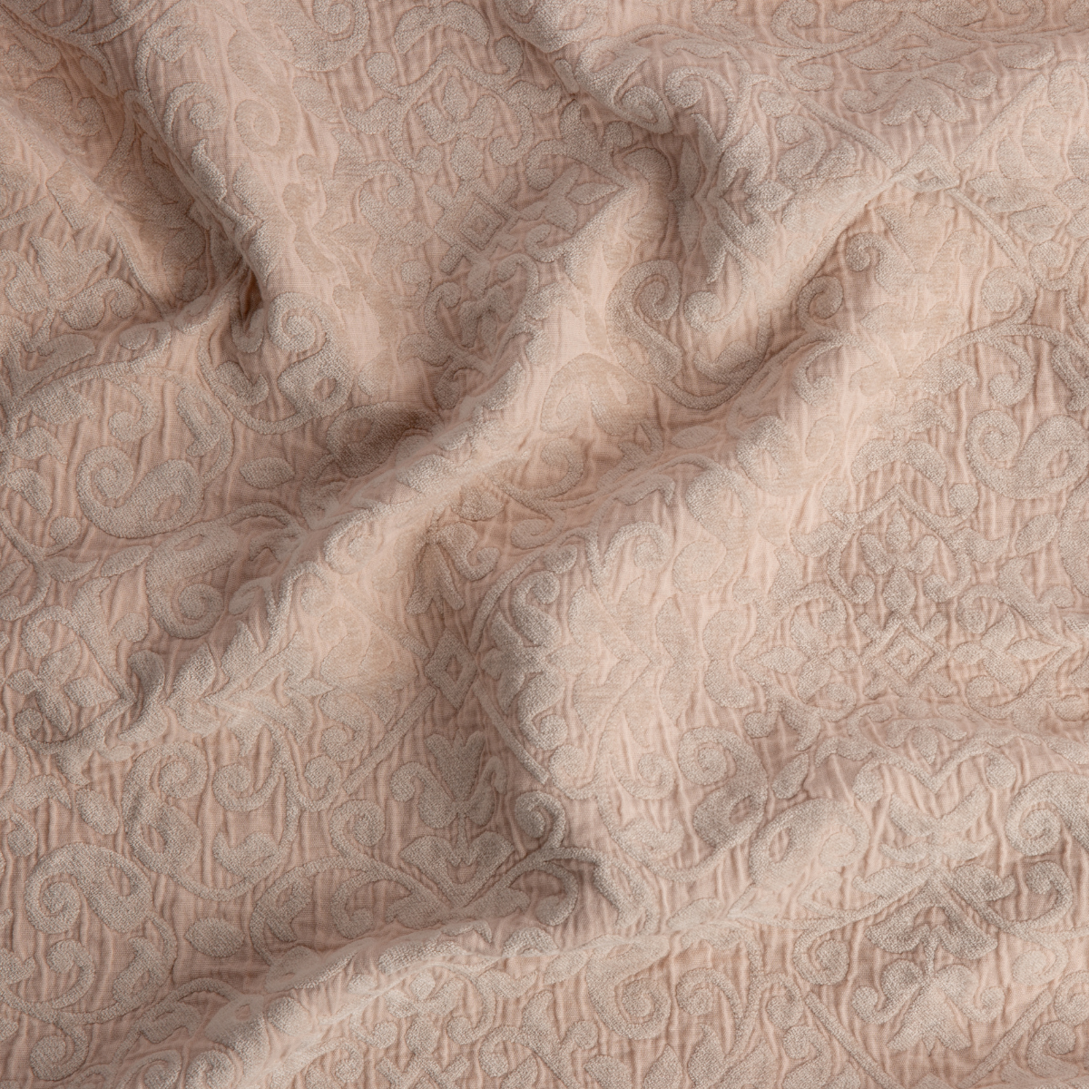 Close-up of Pearl Vienna coverlet showing tonal paisley texture and soft drape.
