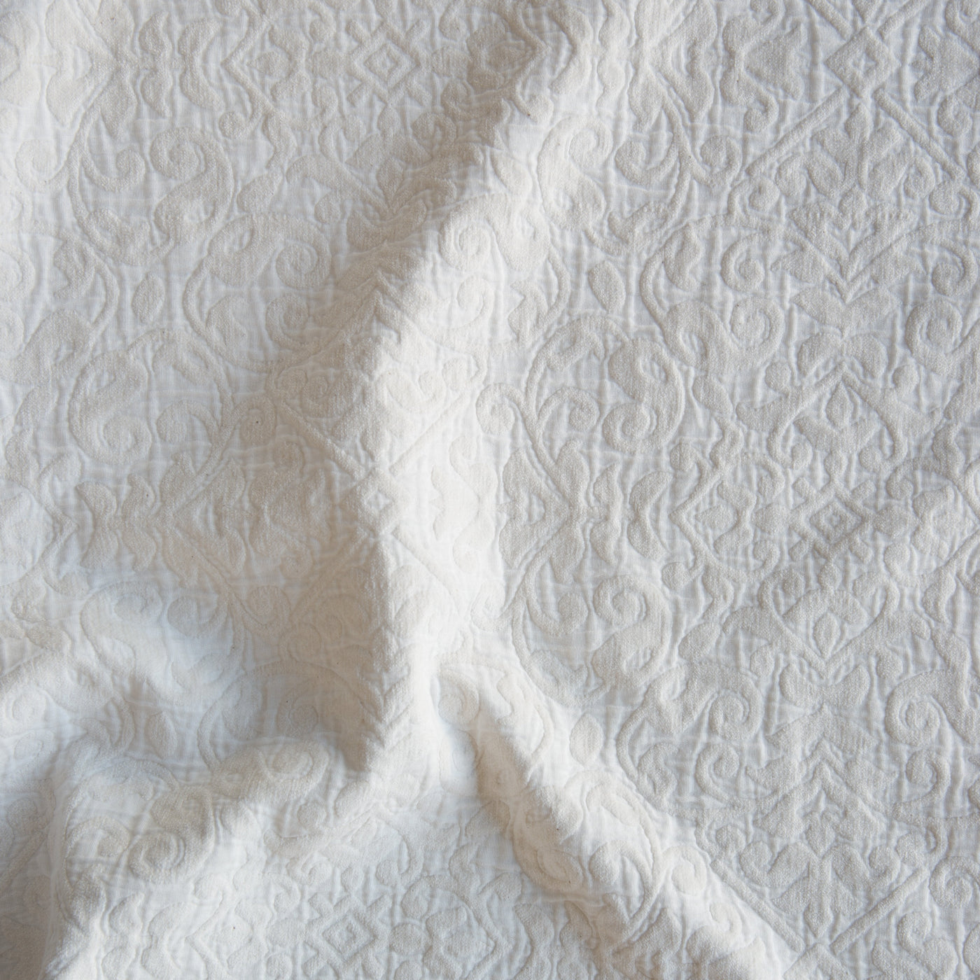 Close-up of Bella Notte Vienna coverlet in Winter White, showing intricate jacquard damask texture.