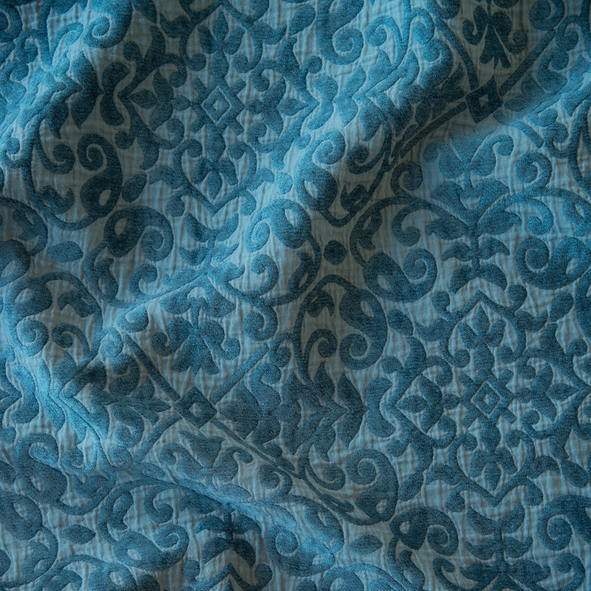 Close-up of Bella Notte Vienna sham in Cenote, showing draped damask jacquard weave detail.