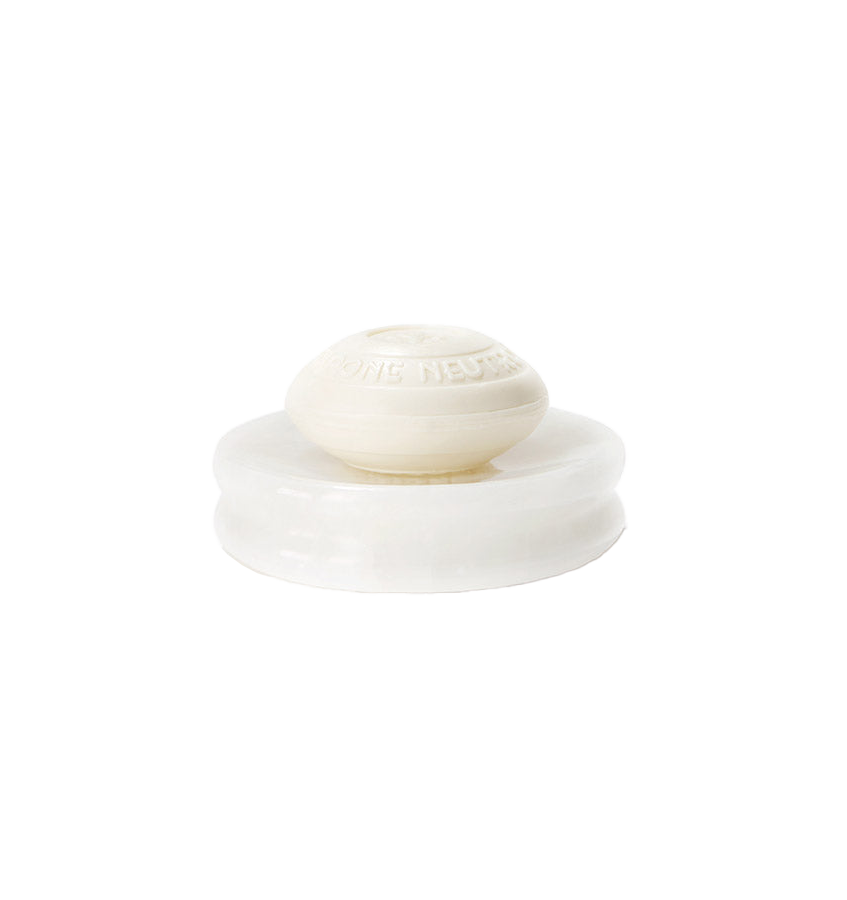 Sferra Volterra ivory alabaster soap dish with oval embossed soap bar on top.