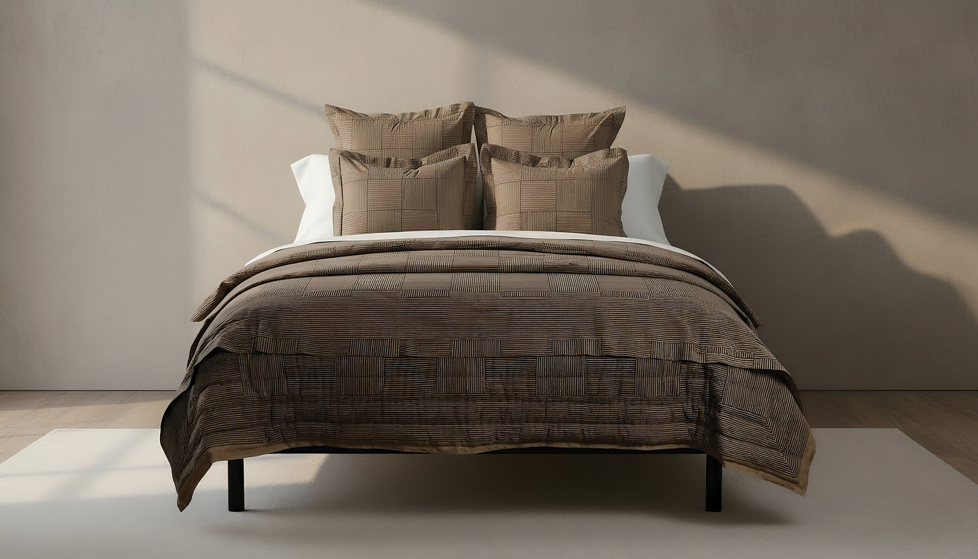 Henry Handwork Wabi Sabi quilt and shams in taupe, styled on a made bed.