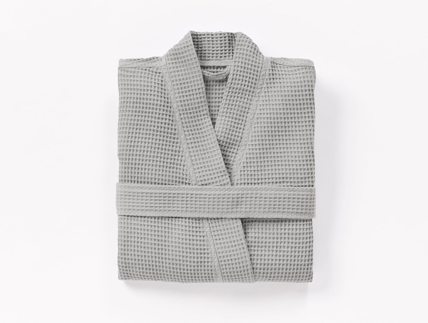 Coyuchi Unisex Waffle Robe in silver grey, folded flat, waffle-knit texture visible.