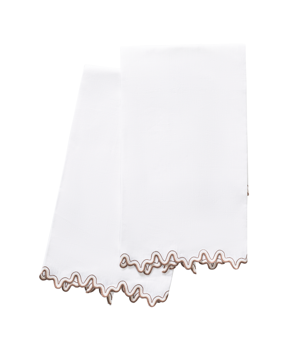 The Wave | Linen Guest Towel Set by Matouk features two white linen guest towels with wavy brown embroidered edges and a two-tone border—an elegant accent for any tabletop.