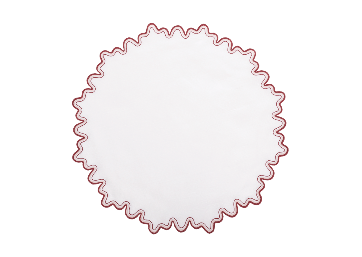 The Wave Placemat by Matouk features a round white linen-textured design with a wavy red two-tone border, shown against a plain white background.