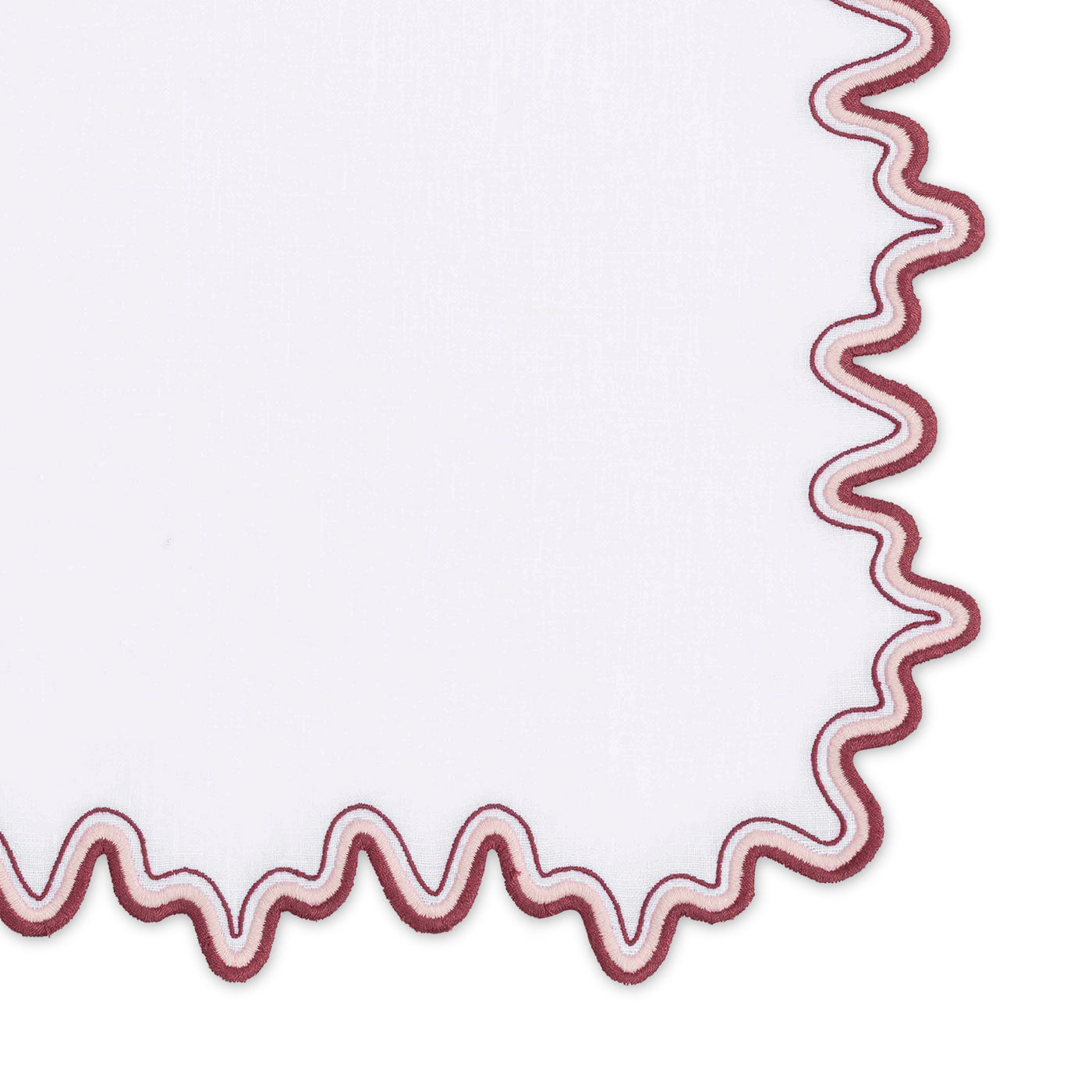 The Wave | Linen Guest Towel Set by Matouk features white linen with a wavy two-tone maroon border, shown partially against a white background.