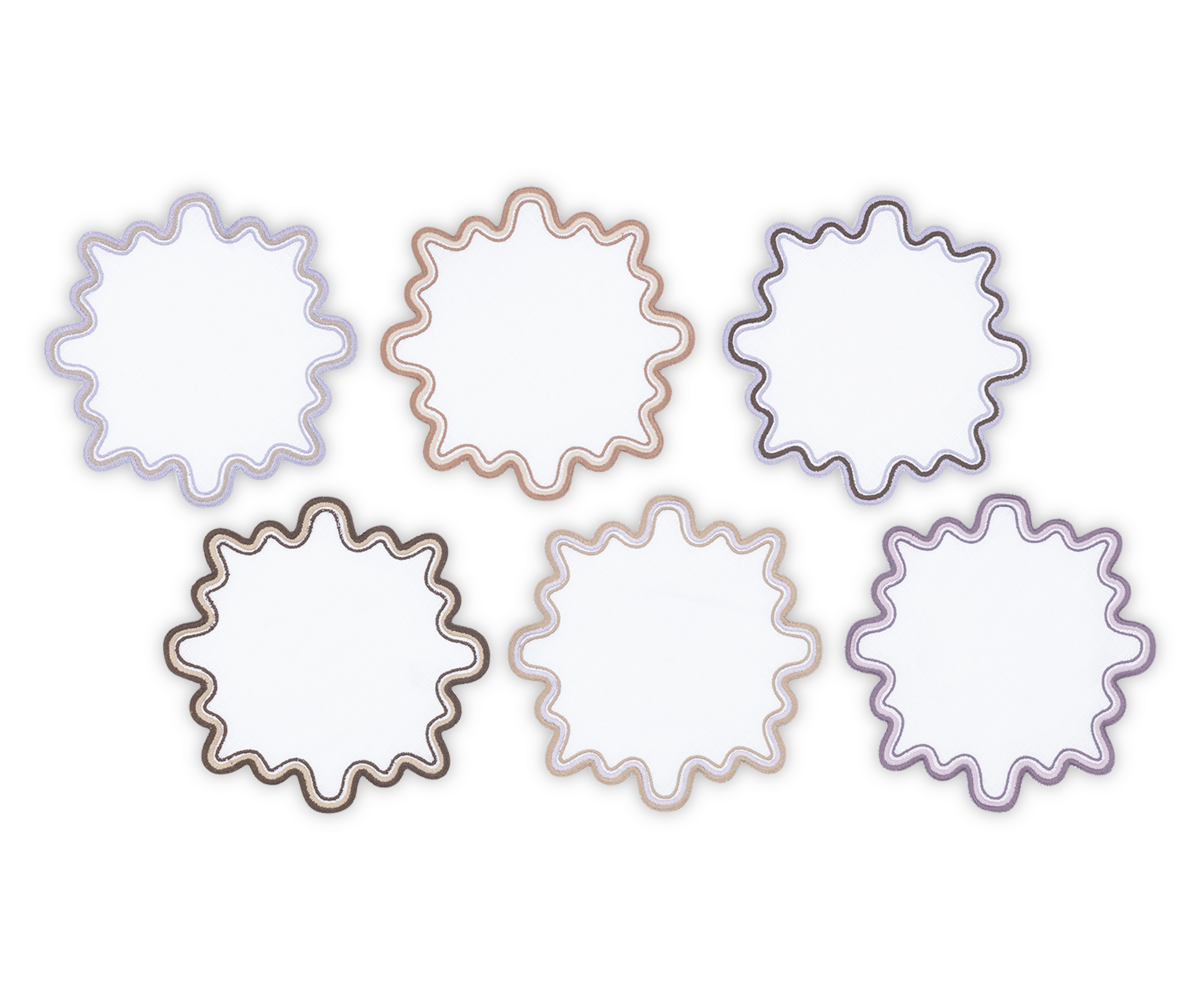 Six wavy-edged linen cocktail napkins from Matouk's Wave set, in assorted pastel shades with a subtle two-tone border, are arranged in two rows on a white background, evoking soft elegance and luxury.