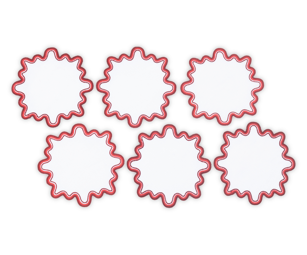 A set of six Wave cocktail napkins by Matouk, made from luxurious white linen with a red wavy two-tone border, is arranged in two rows of three on a plain light background.