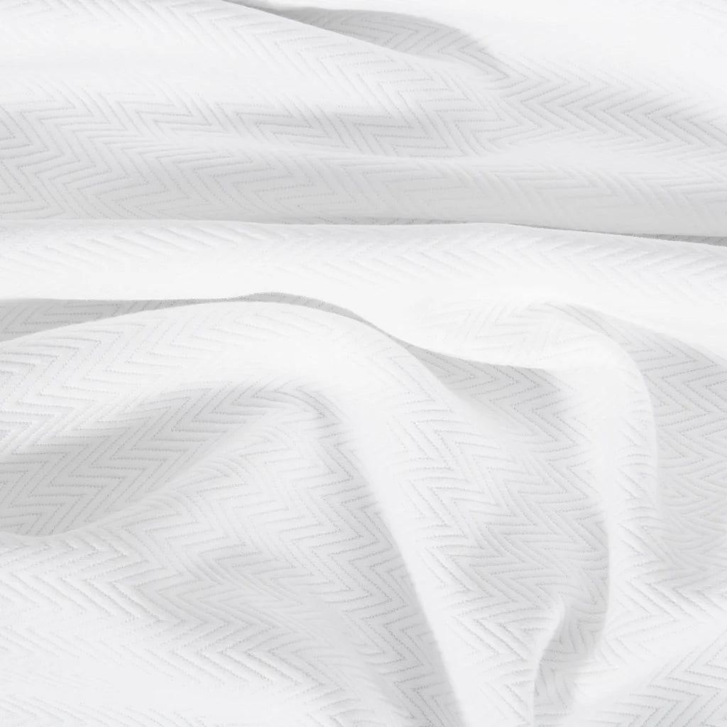 The Waves | Pique Euro Sham Set by Frette features crisp white cotton with a subtle herringbone pattern, evoking hotel luxury. Made in Portugal, this set brings elegant comfort to your bedroom.