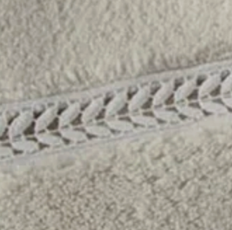 Close-up of Home Treasures Wreath hand towel's embroidered border in stone.