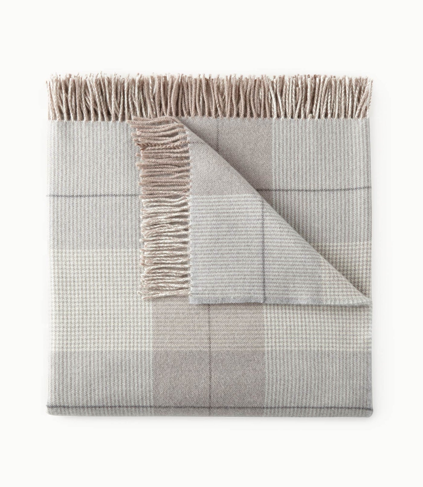 Peacock Alley York wool throw in silver and champagne plaid with fringe trim, folded flat.