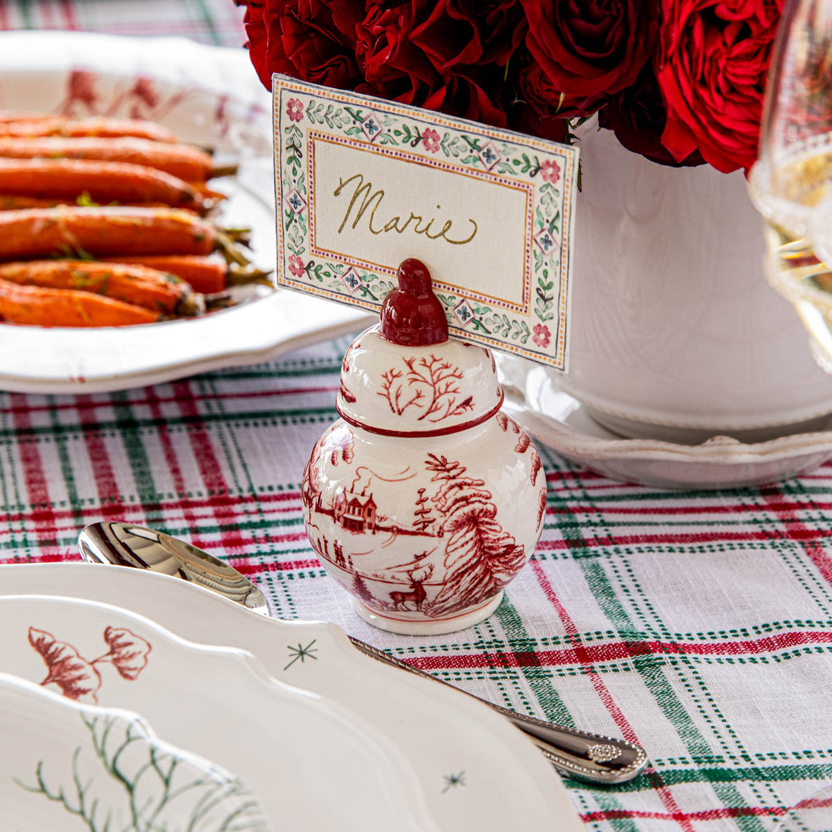 Ruby ginger jar place card holder with a place card beside roasted carrots