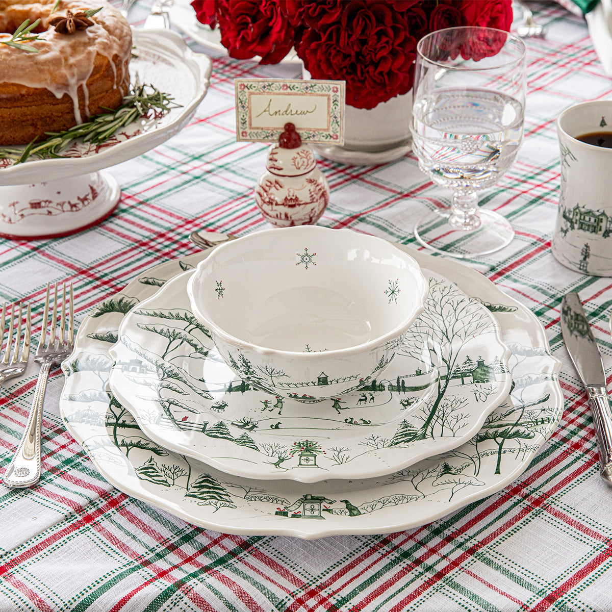 Evergreen Winter Frolic place setting on a red and green plaid tablecloth