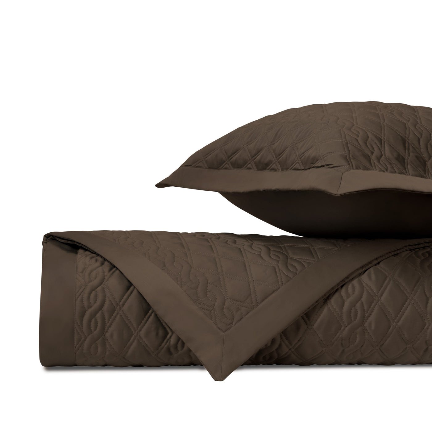 Close-up of Abbey quilted coverlet in chocolate with embossed diamond and floral stitching detail.