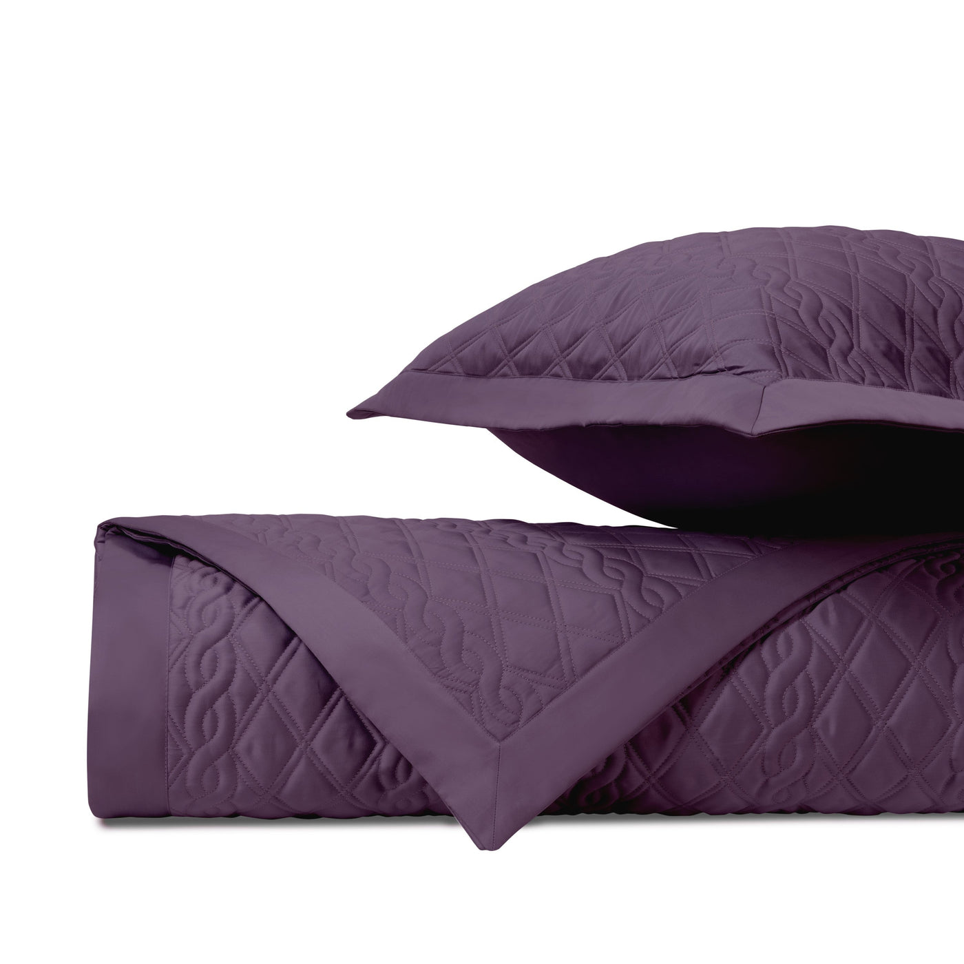 Close-up of Abbey quilted coverlet in plum with diamond and scroll stitching detail.