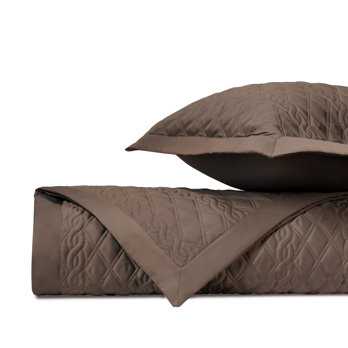Close-up of Abbey quilted coverlet in mink, showing diamond stitching pattern and folded edge detail.