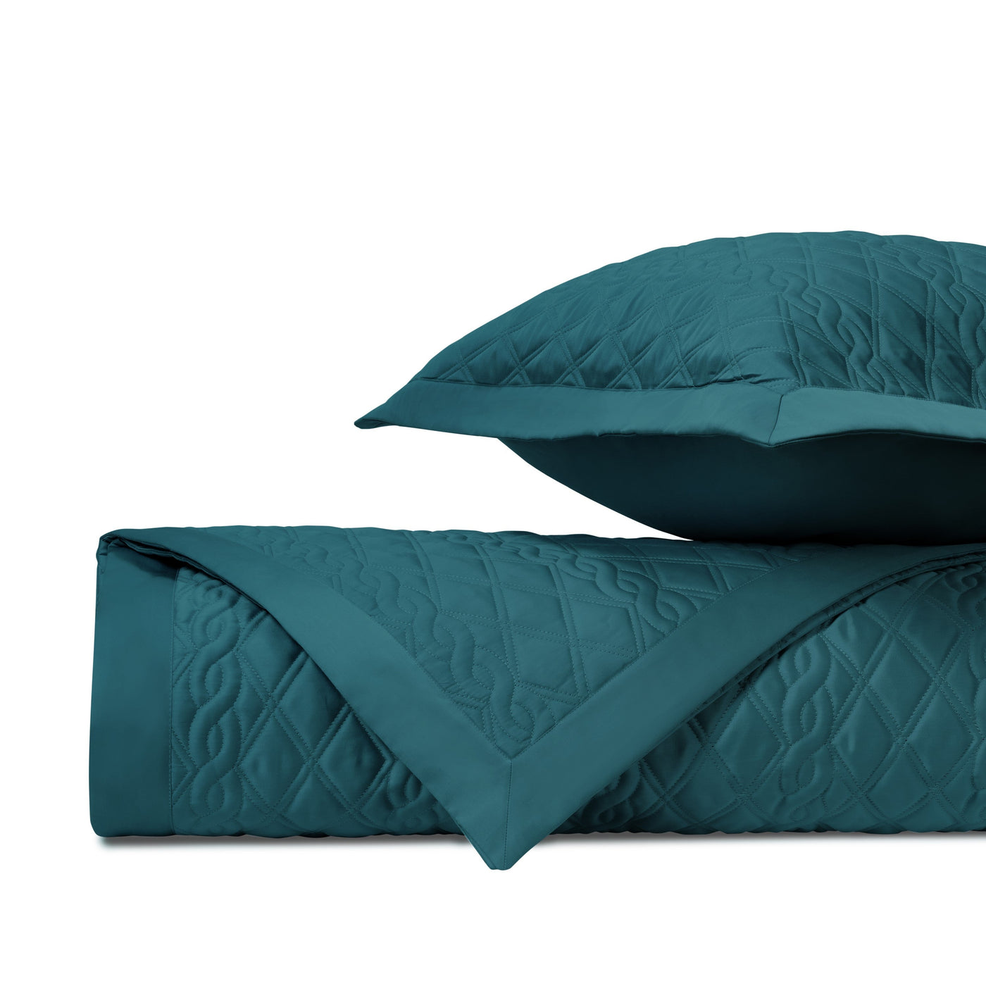 Close-up of Home Treasures Abbey quilted coverlet in teal with diamond and scroll stitching.