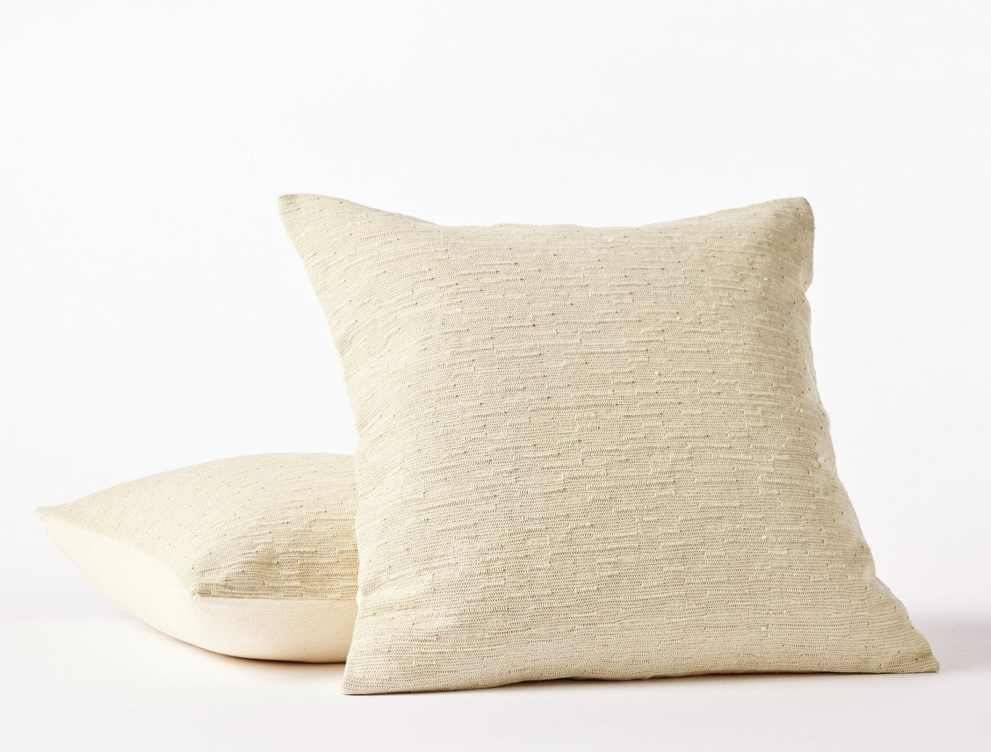 Coyuchi Toro Canyon pillow covers in natural, showing textured woven front and plain back.
