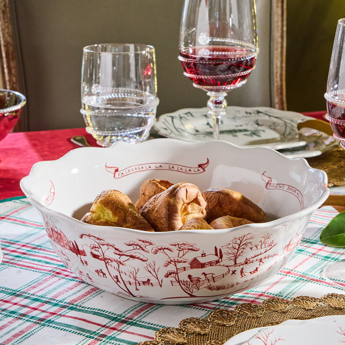 Ruby Winter Frolic serving bowl of dinner rolls on a plaid tablecloth