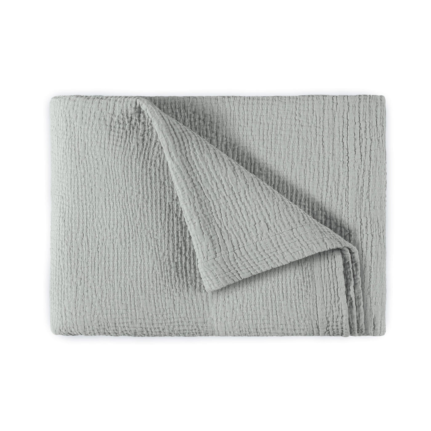 Folded silver-grey textured cotton bedspread with corner turned back revealing reverse side.