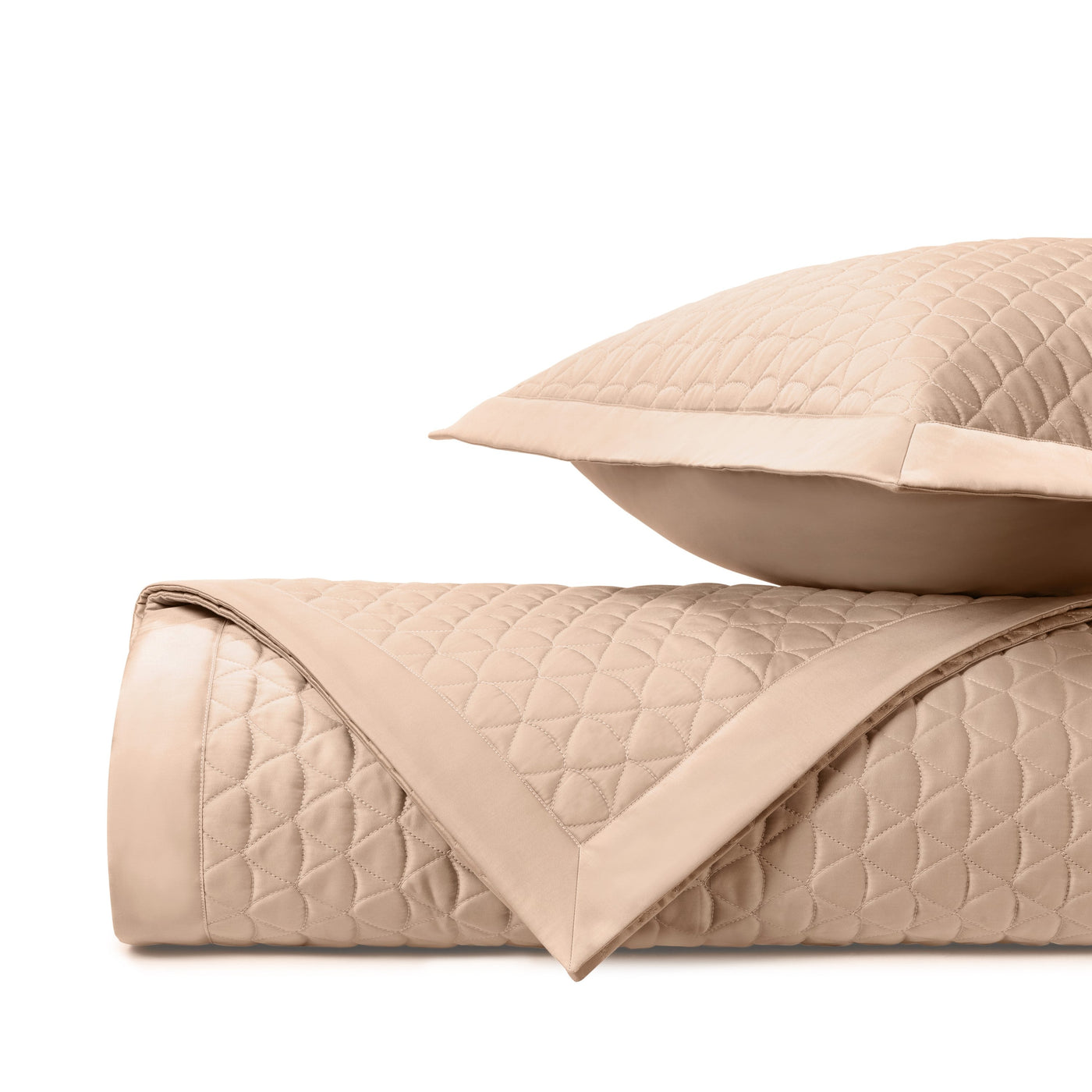 Close-up of Home Treasures Anastasia quilted coverlet in champagne with diamond stitching and satin border.