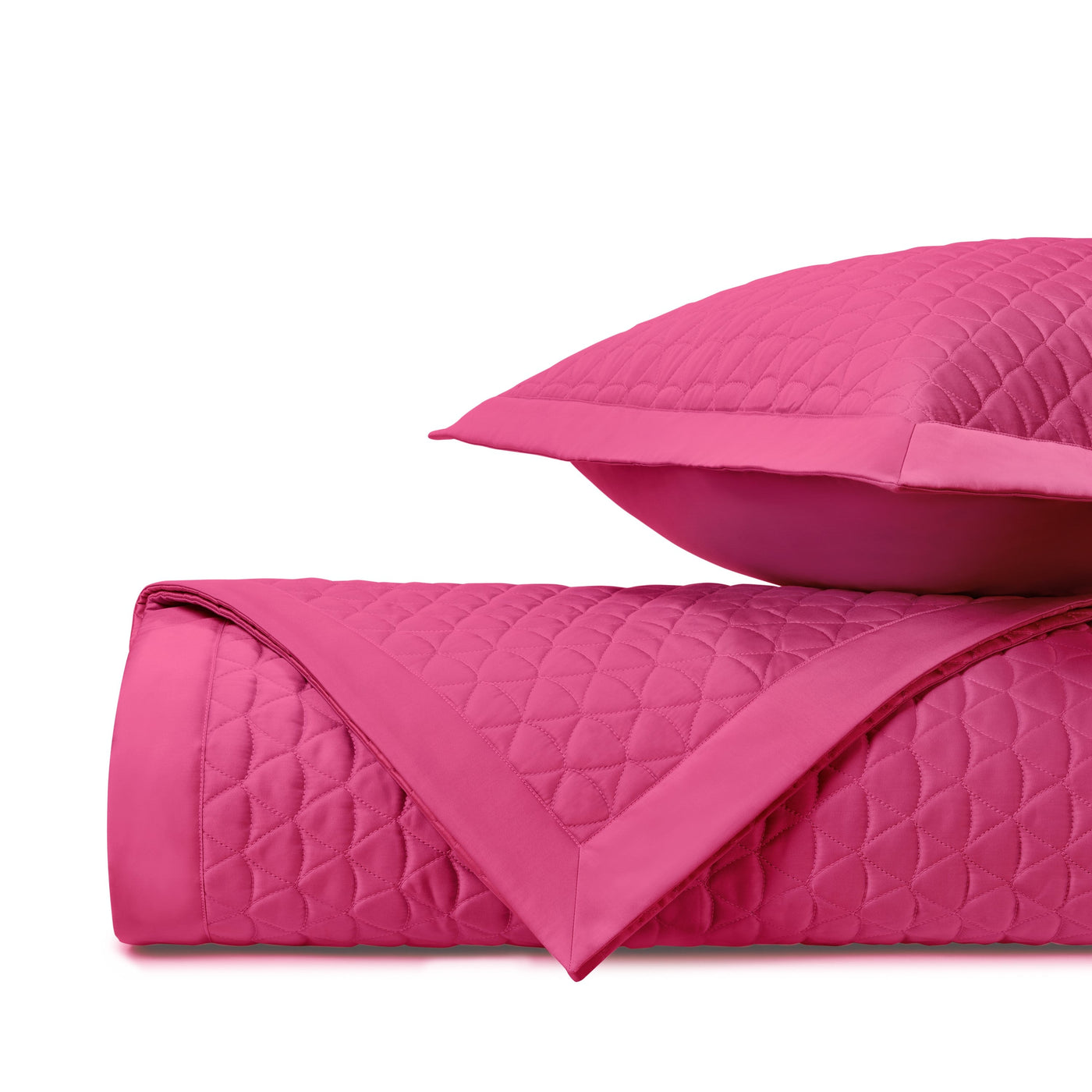 Close-up of fuchsia diamond-quilted fabric with satin border detail.