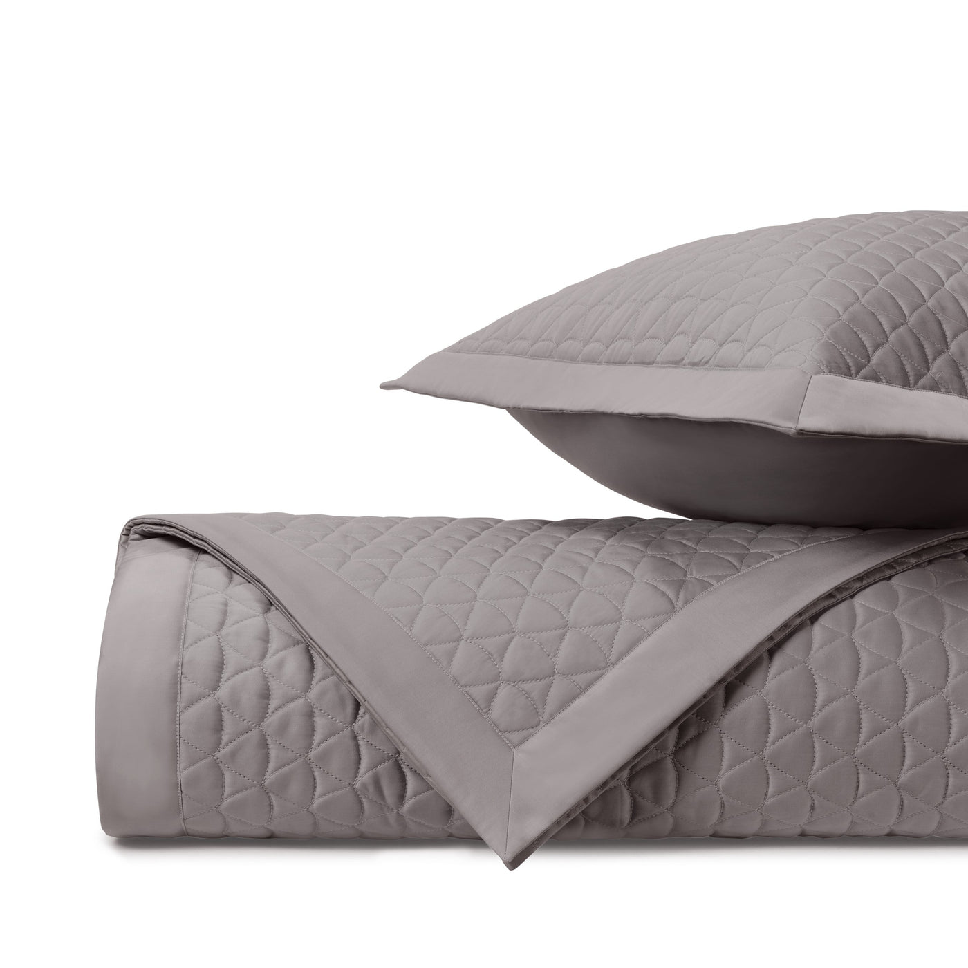 Rolled coverlet showing diamond quilt stitching in pewter with coordinating sham.