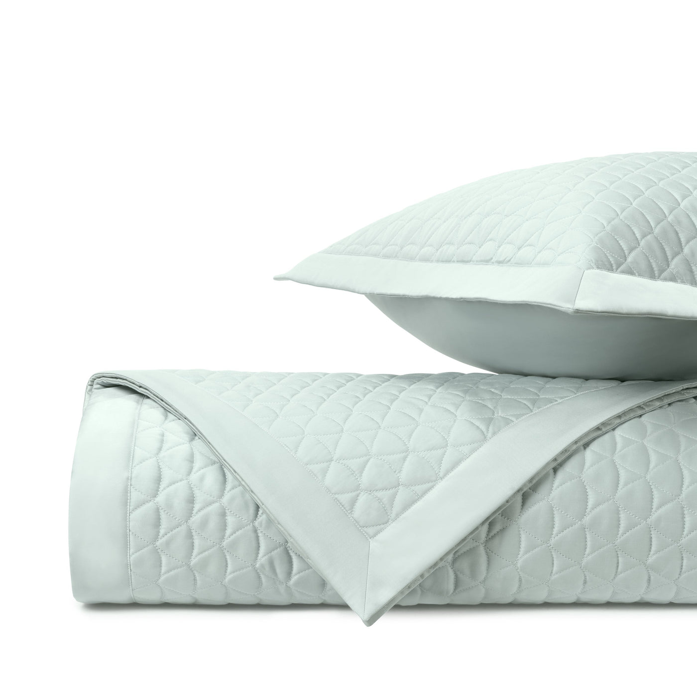 Close-up of Home Treasures Anastasia quilted coverlet in pale aqua with diamond stitching and satin border.