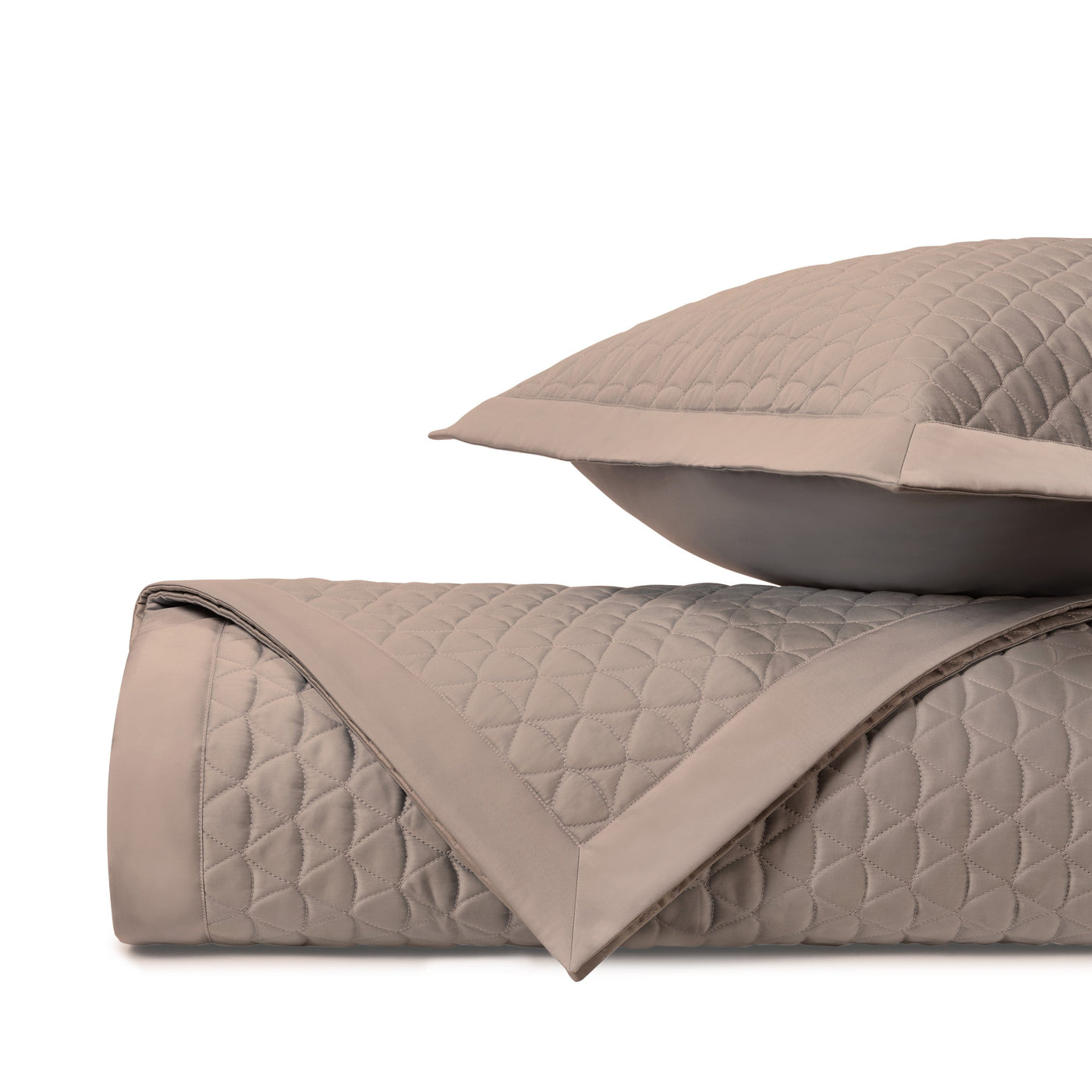 Close-up of Anastasia quilted coverlet in taupe with diamond stitching and satin border trim.