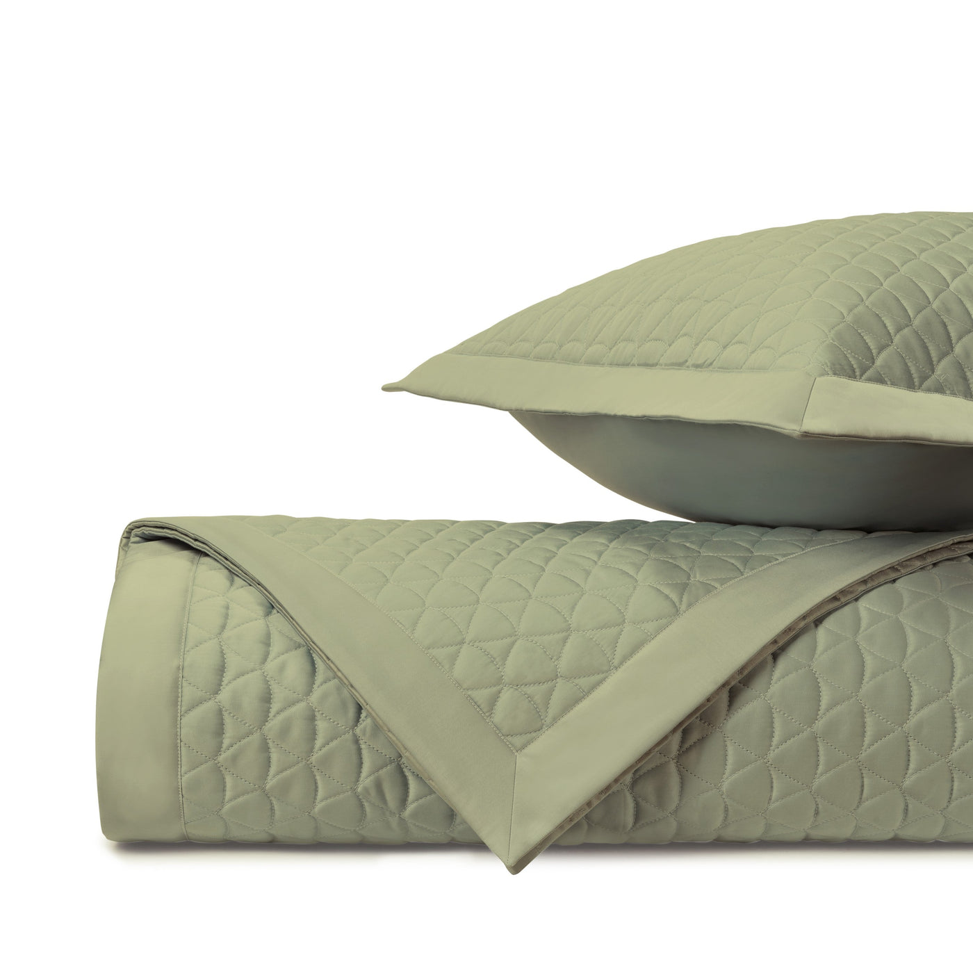 Close-up of sage green diamond quilted coverlet with coordinating sham and flat border trim.