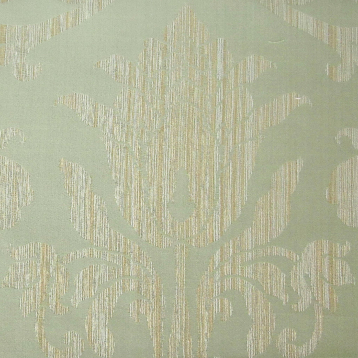 Close-up of sage green jacquard weave with ivory damask floral motif.