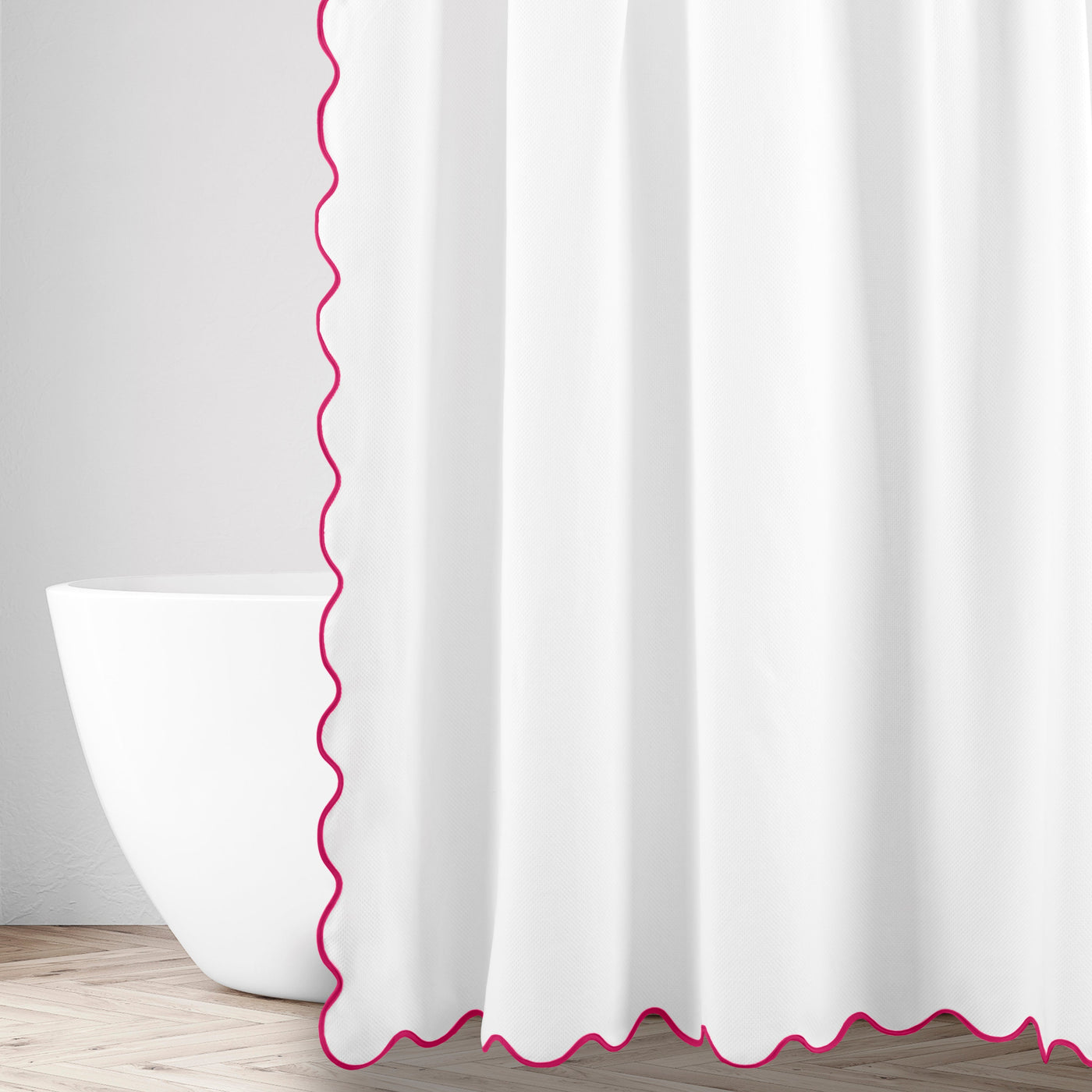 Close-up of white fabric with magenta scalloped trim edge detail.