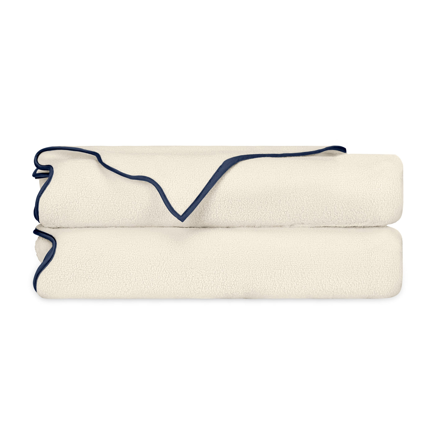 Close-up of ivory textured fabric with navy scalloped trim edge.