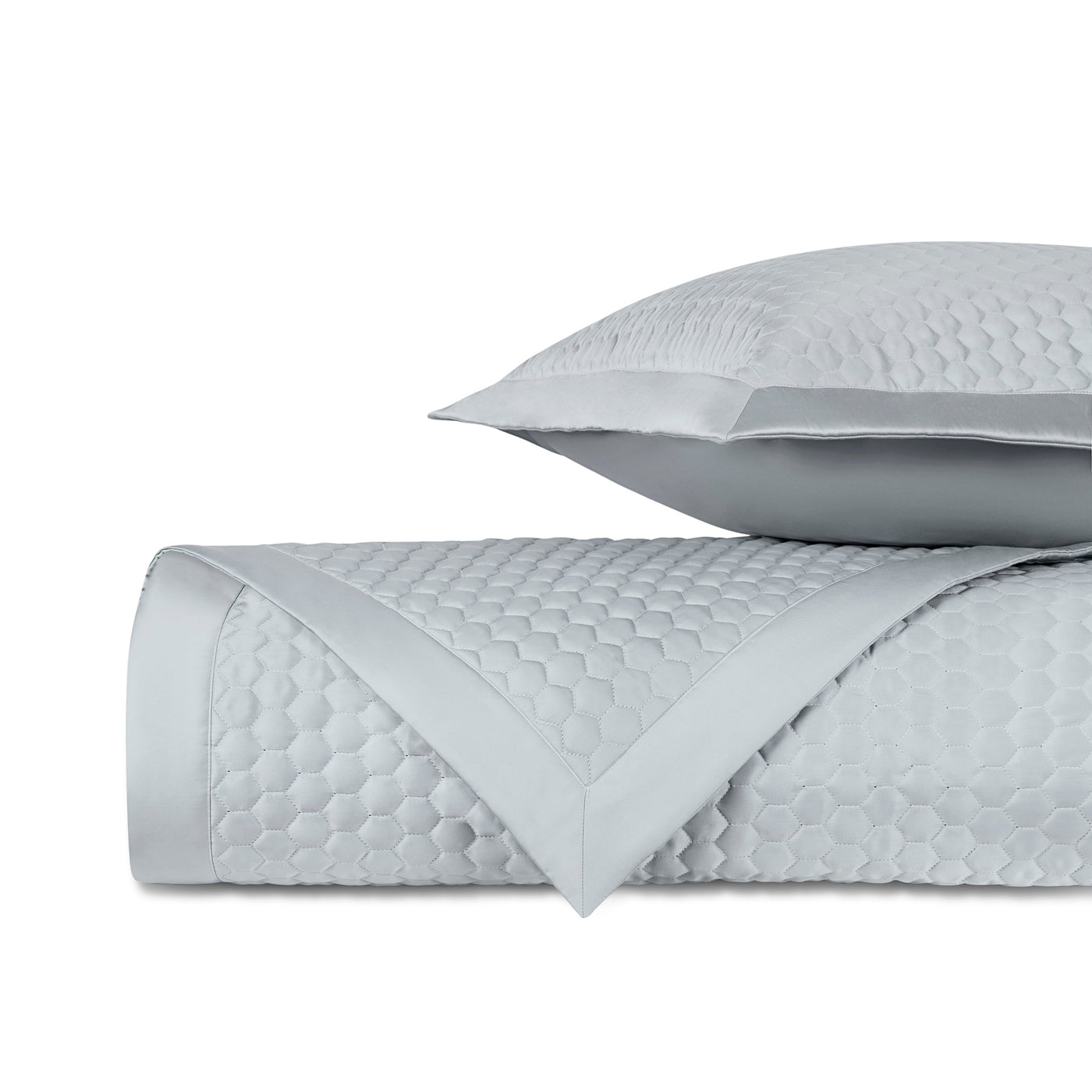 Honeycomb quilted texture detail on Home Treasures Apiary coverlet in silver blue.