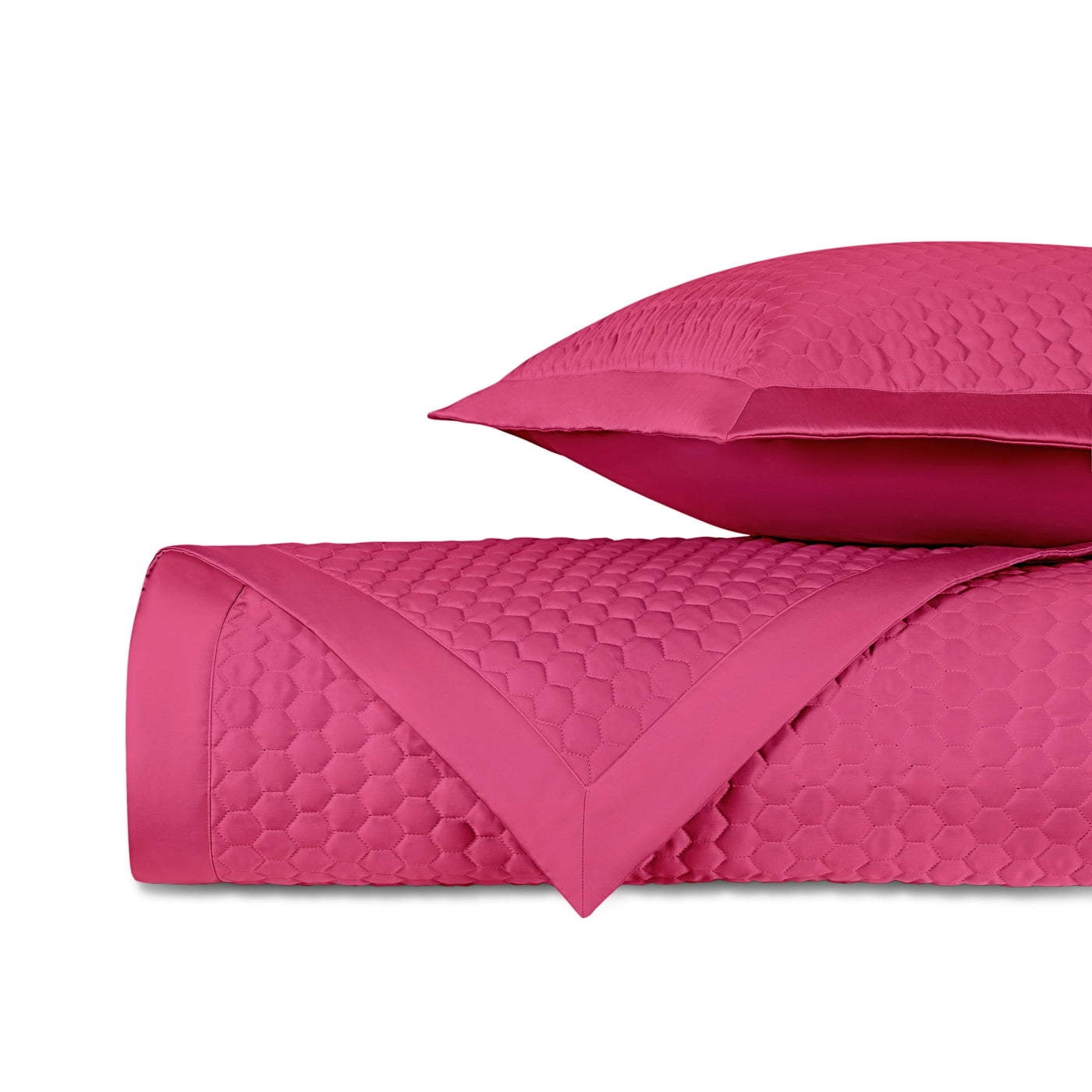 Honeycomb-quilted fuchsia satin with satin border, shown folded with matching pillow sham.