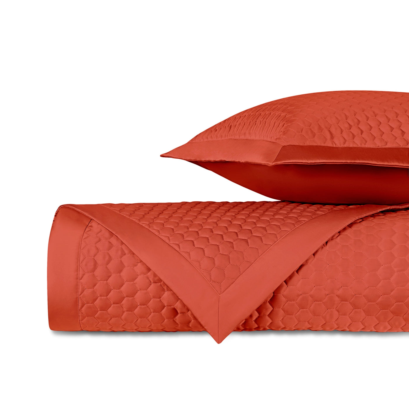 Rolled terracotta quilted fabric with honeycomb texture and satin border, with matching sham.
