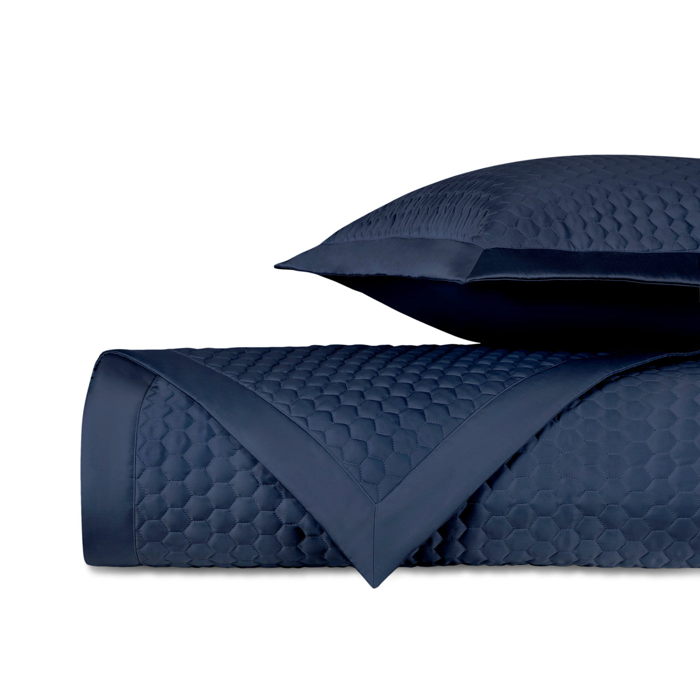 Close-up of navy quilted yardage with honeycomb texture and satin border trim.