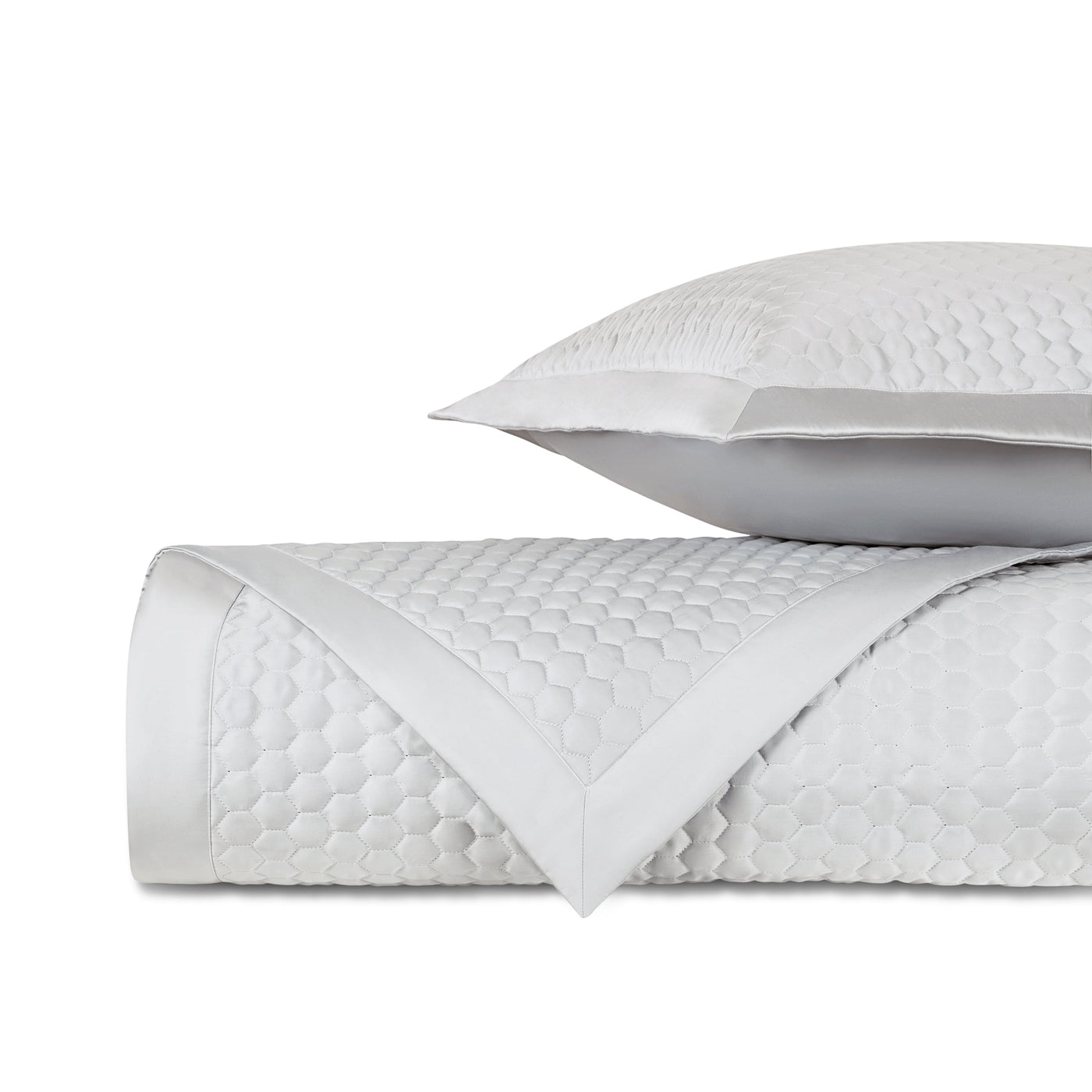 Rolled ivory quilted fabric with honeycomb texture and satin border, with matching pillow.
