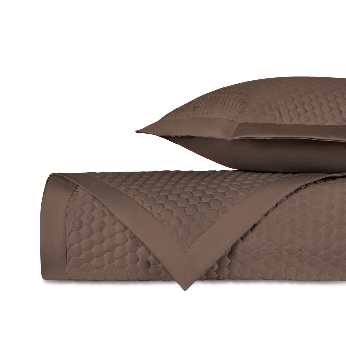 Close-up of Apiary quilted yardage in tobacco, showing honeycomb texture and satin border detail.
