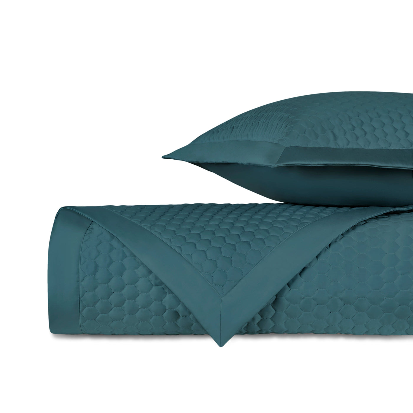 Teal quilted texture detail showing honeycomb stitch pattern on Apiary coverlet.