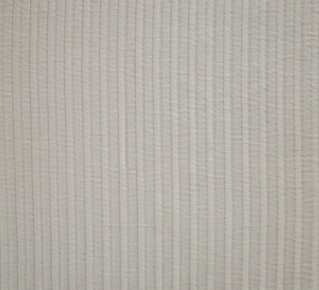 Close-up of ivory woven cotton coverlet with tonal vertical stripe texture.