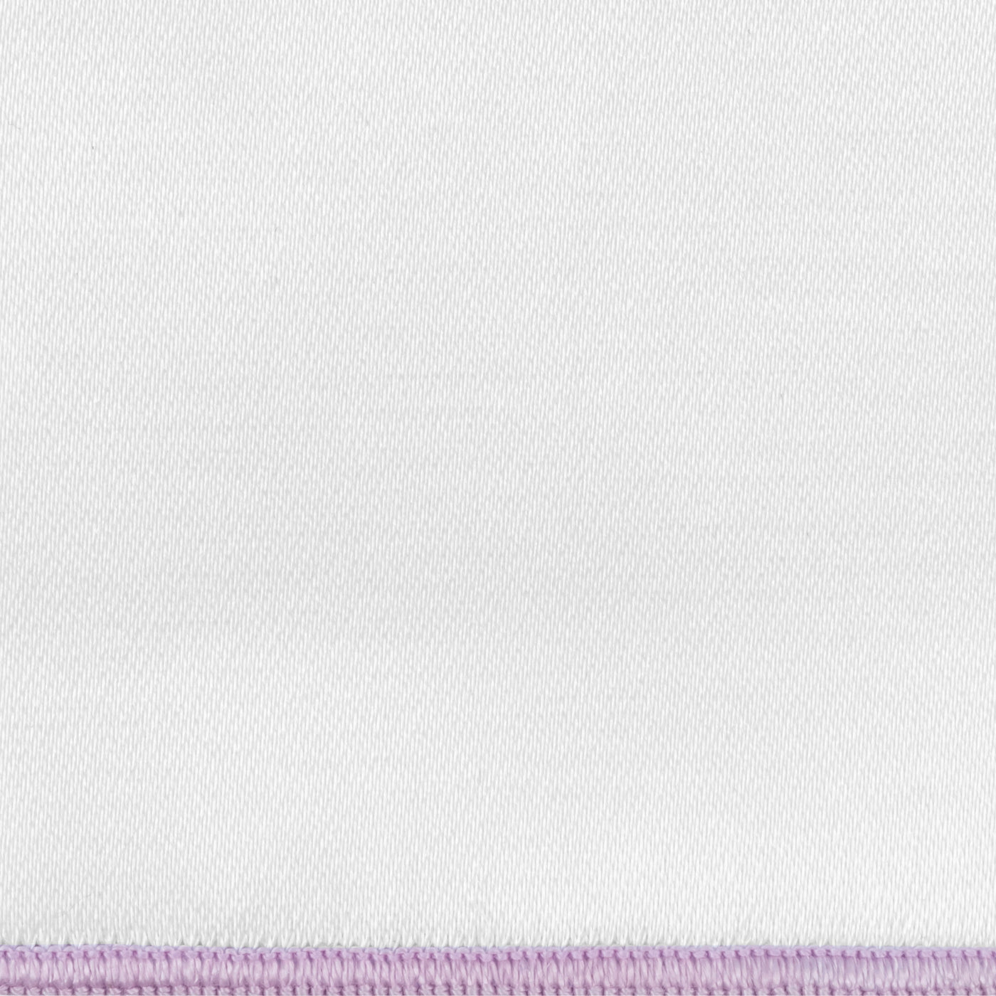 Close-up of white linen fabric with a lavender whipstitch border edge.