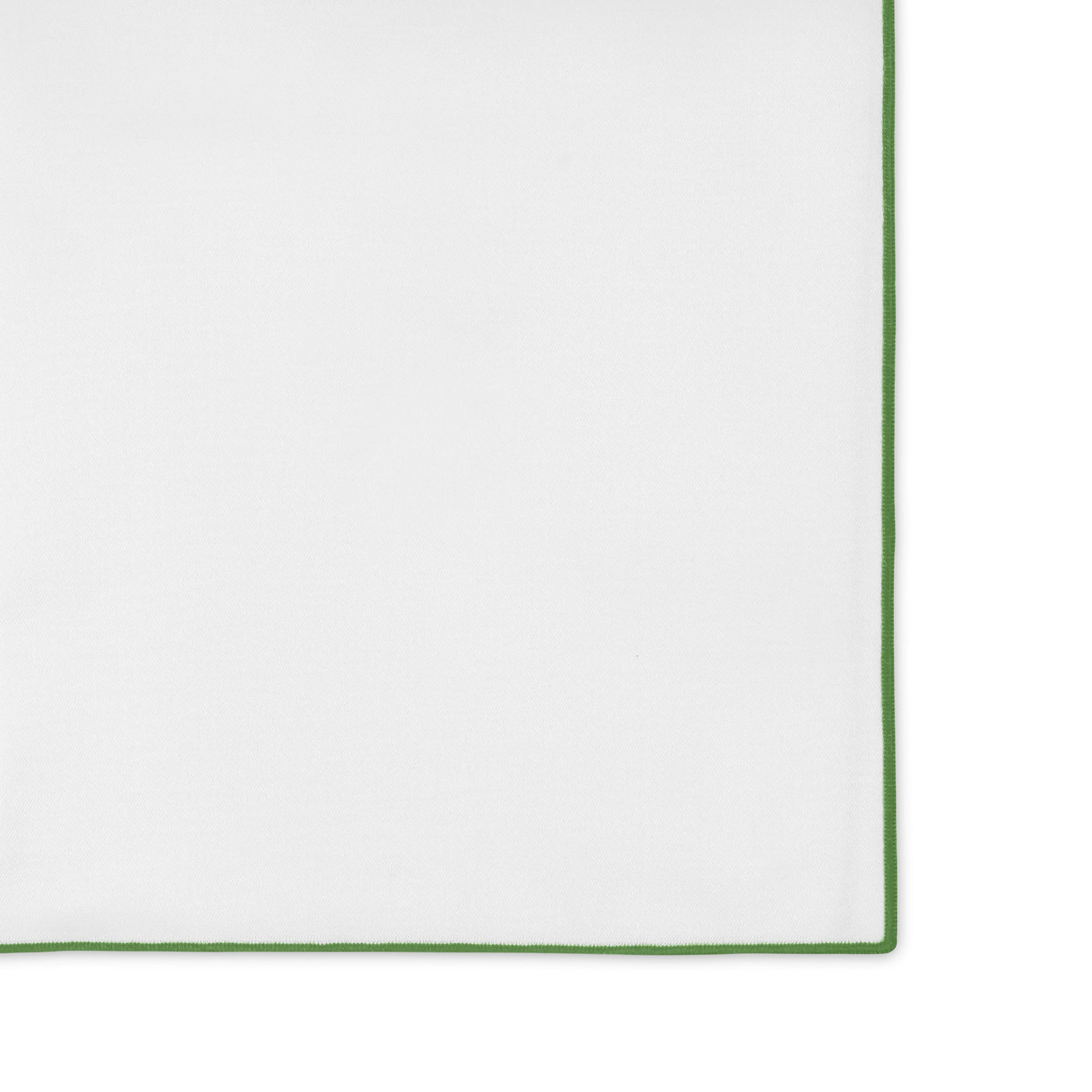 Corner detail showing white linen with green whipstitch border trim.